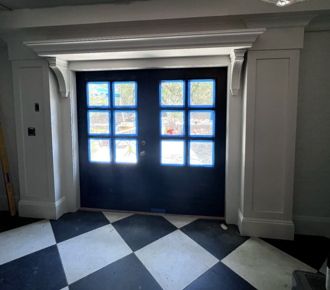 Classical door surround with pilasters, corbels and crown molding