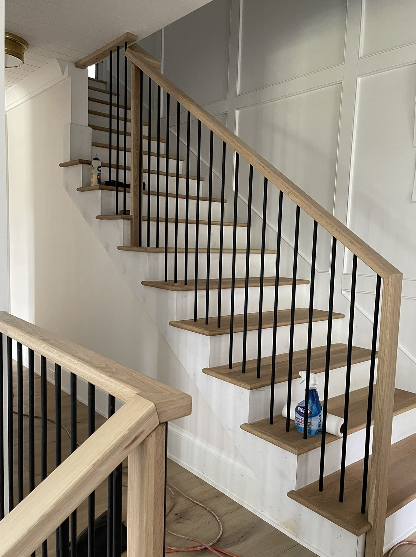 White oak staircase with black metal balusters, first to second floor
