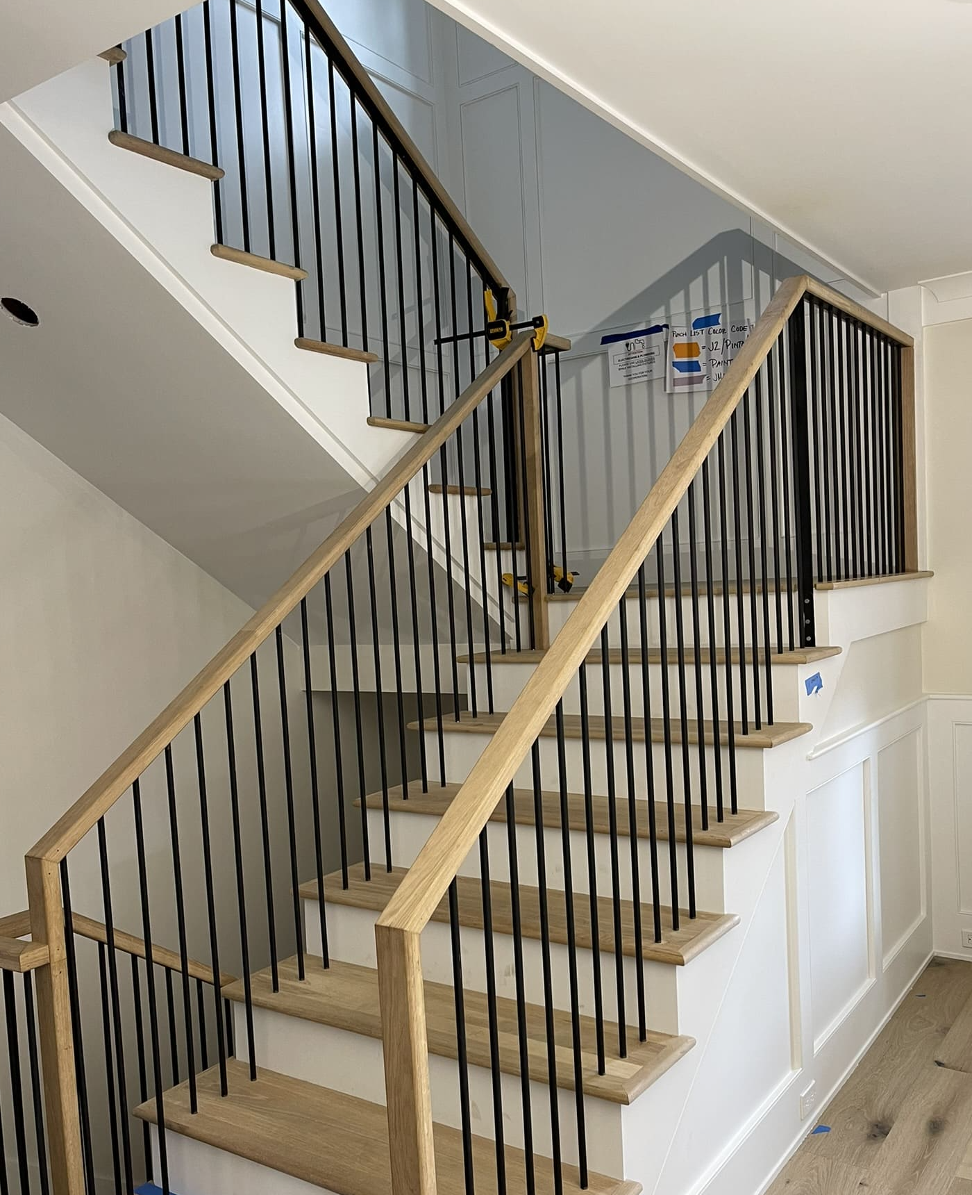 White oak staircase with board-and-batten wainscot, second to third floor