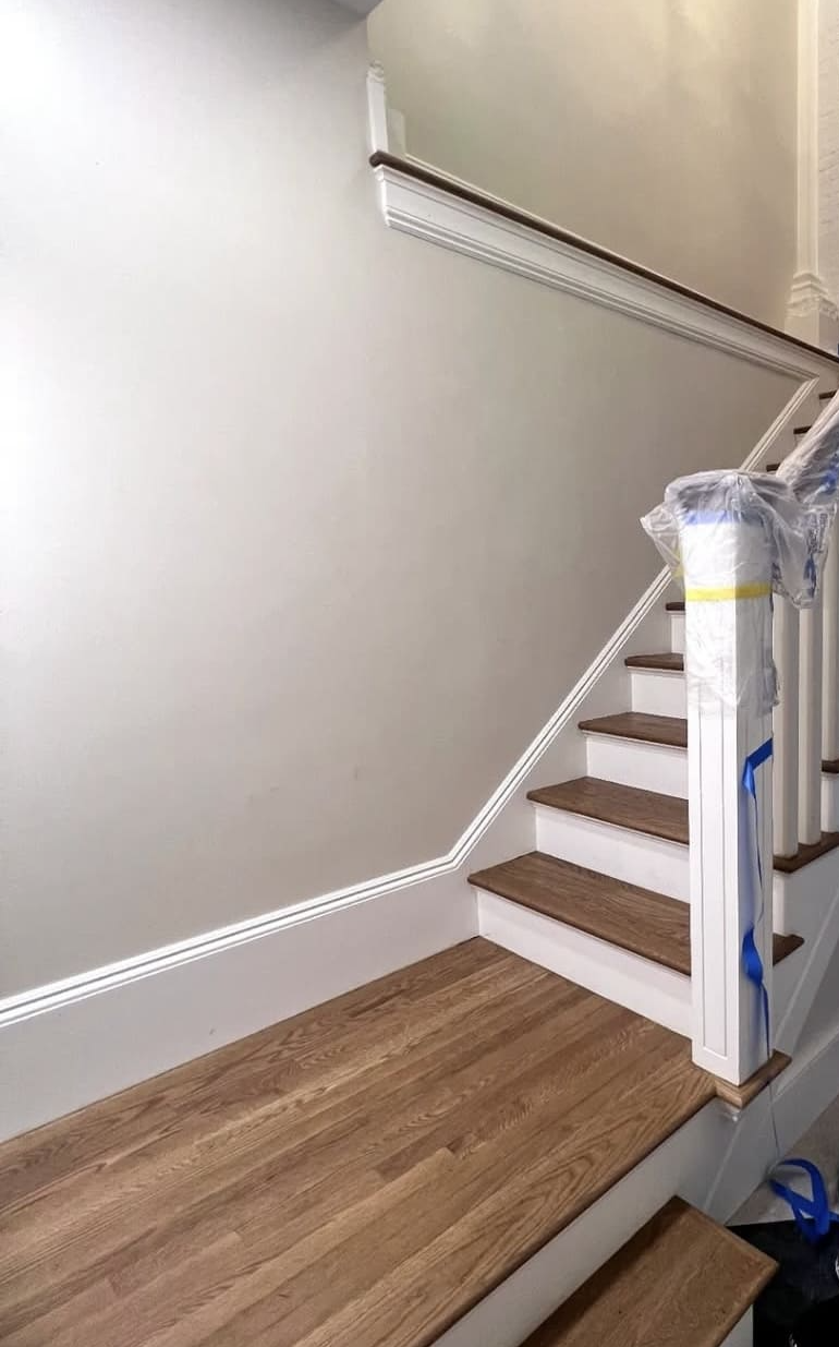 Staircase lower flight with raked skirt board and chair rail